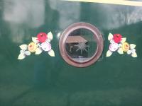 Traditional style vinyl canal roses either side of porthole